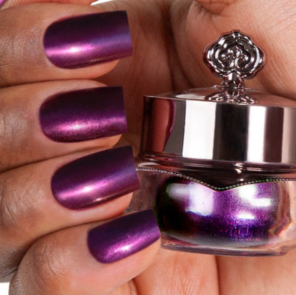Nails showing dark purple shade with metallic effect