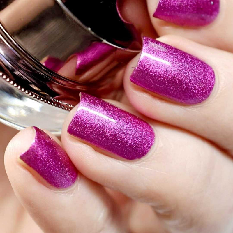 Nails showing hot pink shade with metallic effect