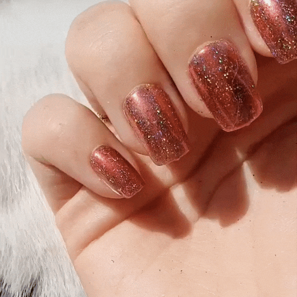 Nails showing shade of pink with holographic shine