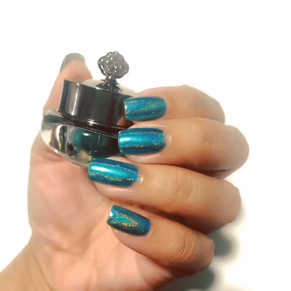 Nails showing bright emerald shade with holographic shine