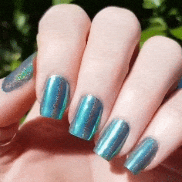 Nails showing bright emerald shade with holographic shine